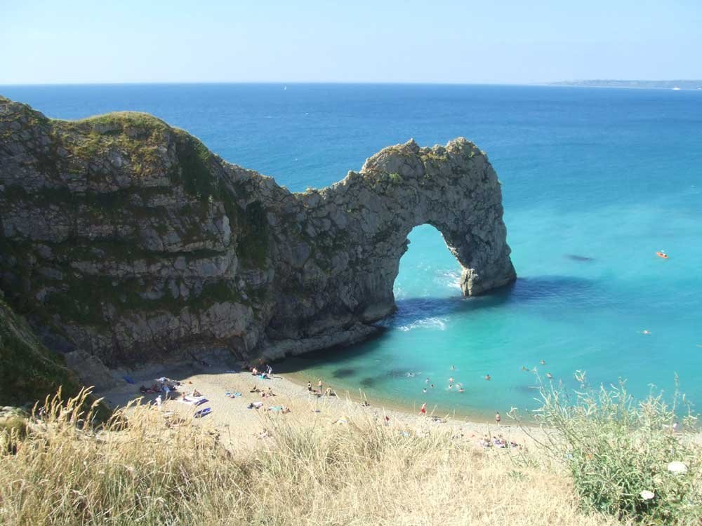 Durdle Door view of Durdle Door, blue sea, sand, Dorset, England