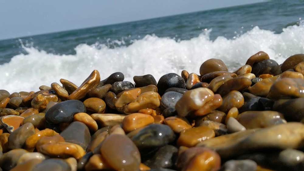 Wet Pebbles with sea crashing behind, Norfolk Beaches, Weybourne, Norfolk
